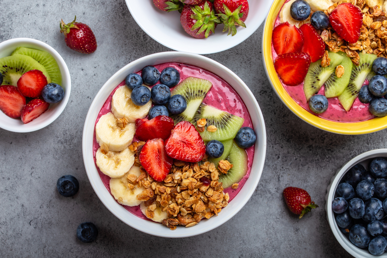 Bowls of fresh fruit, berries and whole grains arranged as a PCOD-friendly balanced meal