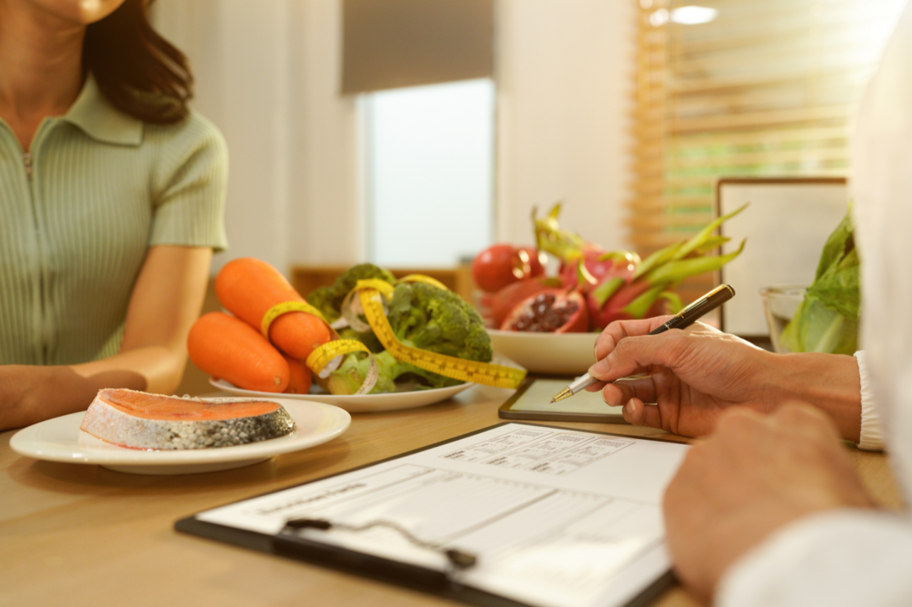 Measuring tape beside fresh vegetables representing healthy weight and BMI management